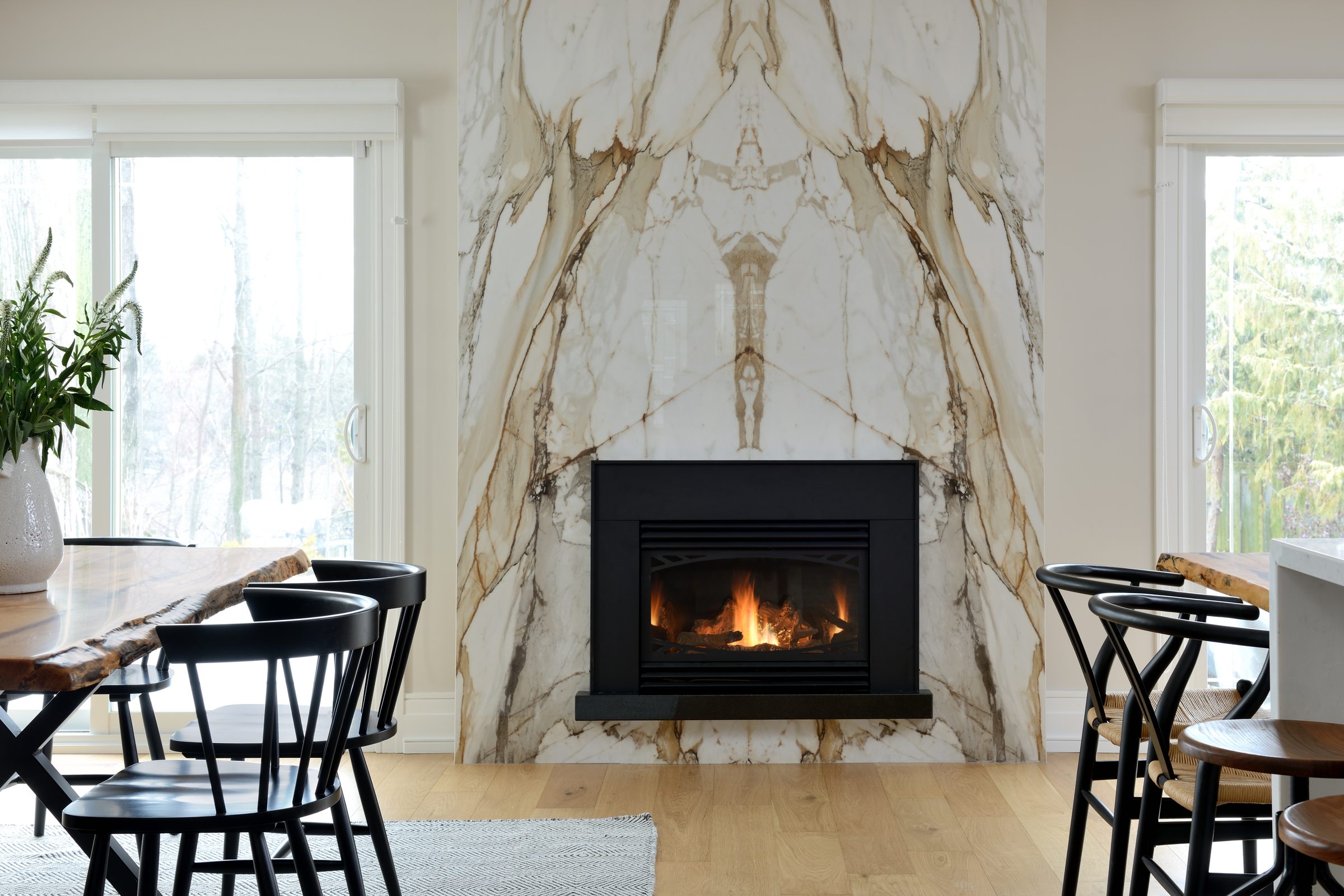 A great room with a stone fireplace